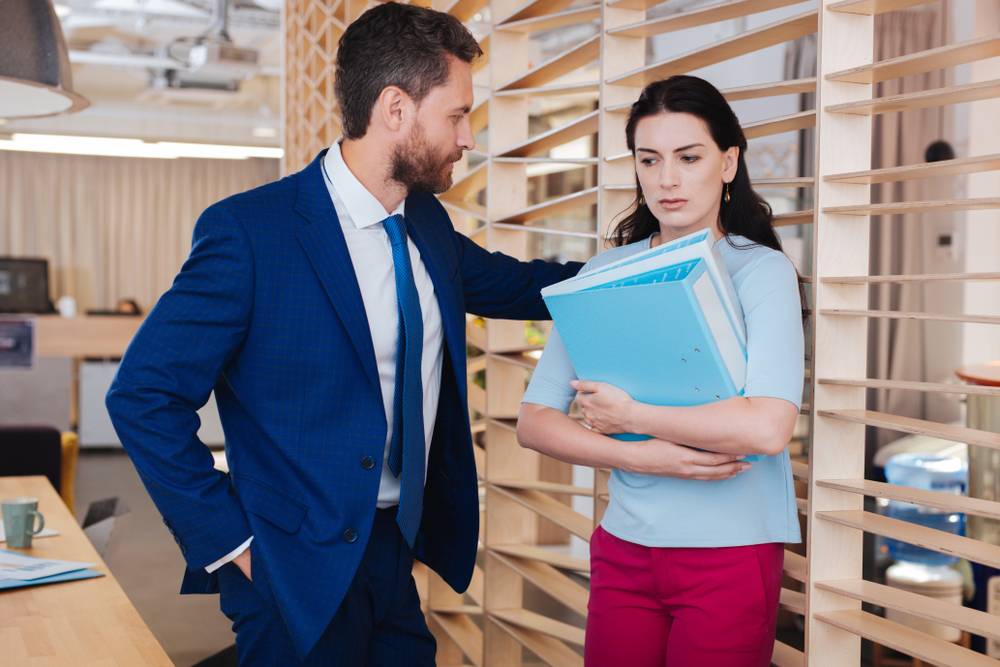 man makes female colleague uncomfortable in the office